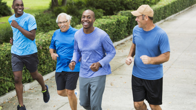 Four multiracial men jogging in park - Stock image Men, Only Men, Running, Multi-Ethnic Group, Exercising