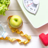 Green apple and Weight scale,measure tape with fresh vegetable, clean water and sport equipment for women diet slimming