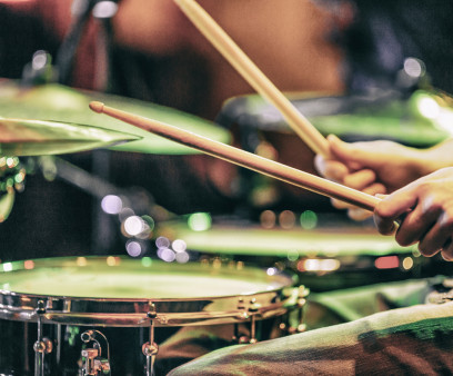 hands playing drums drum sticks