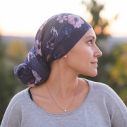 Ethnic woman battling cancer stands outside and contemplates her life